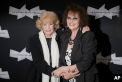 FILE - French actress Jeanne Moreau, left, and Italian actress Claudia Cardinale arrive for the screening of "Gebo et l'Ombre," of Portuguese director Manoel de Oliveira at the Cinematheque Francaise, in Paris, Sept. 6, 2012.
