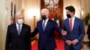 President Joe Biden, center, walks with Mexican President Andrés Manuel López Obrador, left, and Canadian Prime Minister Justin Trudeau, right, to a meeting in the East Room of the White House in Washington, Nov. 18, 2021.