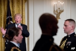 President Donald Trump speaks at a reception for senators and their spouses in the East Room of the White House, in Washington, March 28, 2017.