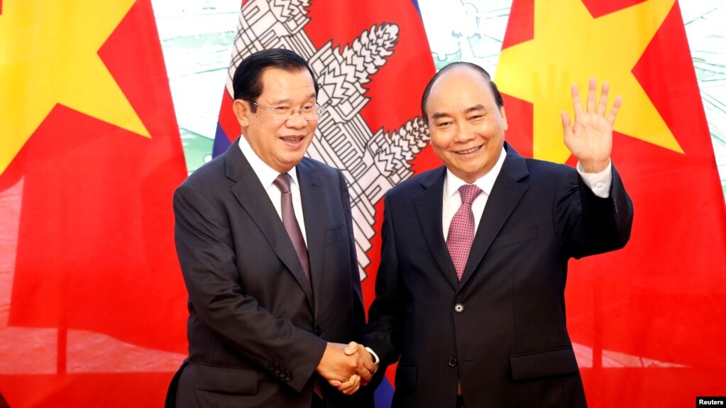 In this photo taken on Oct. 4, 2019, Cambodia's Prime Minister Hun Sen poses for a photo with his Vietnamese counterpart Nguyen Xuan Phuc at the Government Office in Hanoi, Vietnam.