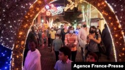 People enjoy Christmas decorations in Melrose Arch, Johannesburg, Dec. 21, 2021. 