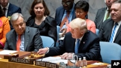 President Donald Trump pounds a gavel before addressing the United Nations Security Council during the 73rd session of the United Nations General Assembly, at U.N. headquarters, Sept. 26, 2018.