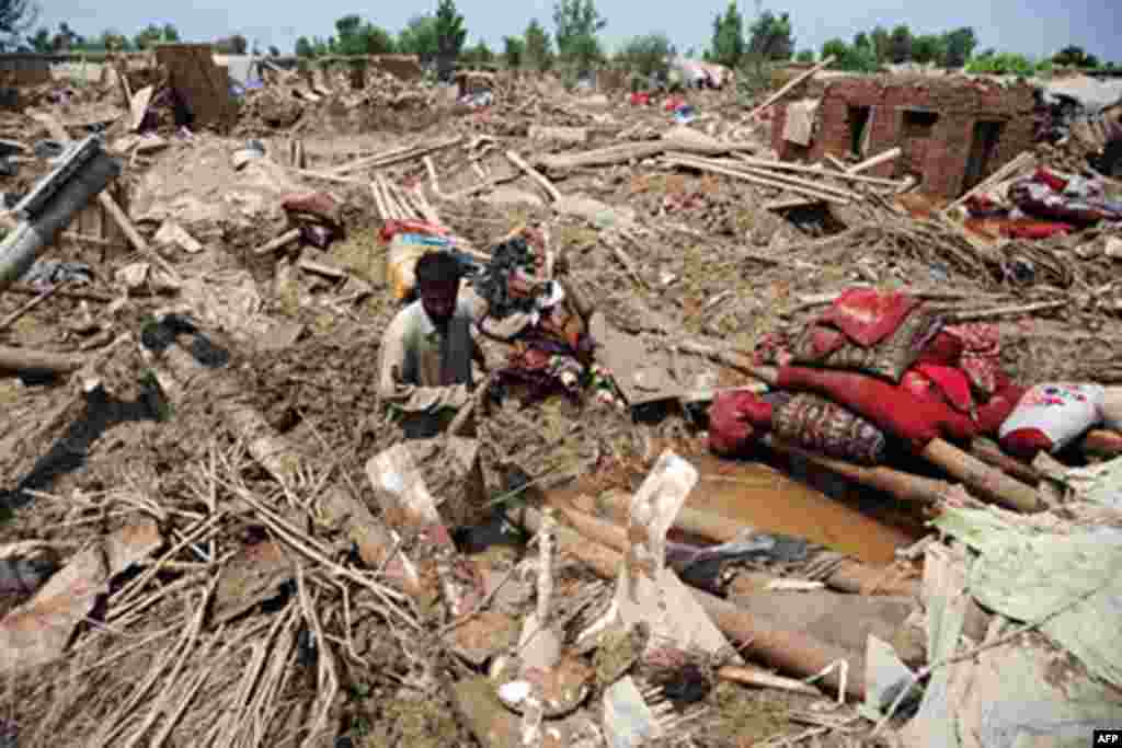 A refugeed Afghan man searches through the debris of his collapsed home after a flash flood at the Azakhal camp on the outskirts of Peshawar on August 2, 2010. Fears were growing Monday for up to 2.5 million people affected by Pakistan's worst floods in 8