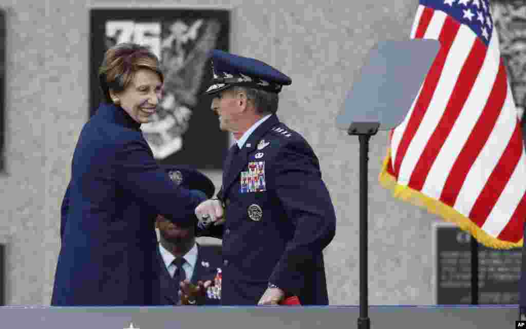 La secretaria de la Fuerza Aérea de Estados Unidos, Barbara Barrett, a la izquierda, usa su codo para saludar al general de la Fuerza Aérea y jefe de gabinete de la FF.AA., David Goldfein, mientras se dirige al podio.