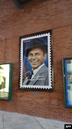 A poster of a US postage stamp depicting Frank Sinatra is seen on Dec. 8, 2015 at the entrance of the Hoboken Historical Museum in Hoboken, New Jersey.