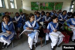 Students listen to their teacher during a lesson at the Islamabad College for girls in Islamabad, Pakistan, Oct. 13, 2017.