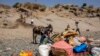 FILE - Refugees who fled the conflict in Ethiopia's Tigray region arrive with their furniture and donkey on the banks of the Tekeze River on the Sudan-Ethiopia border, in Hamdayet, eastern Sudan, Nov. 21, 2020. 