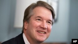 FILE - Supreme Court nominee Judge Brett Kavanaugh smiles during a meeting with Sen. Mike Lee, R-Utah, on Capitol Hill in Washington, July 18, 2018.