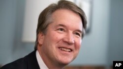 FILE - Supreme Court nominee Judge Brett Kavanaugh smiles during a meeting with Sen. Mike Lee, R-Utah, on Capitol Hill in Washington, July 18, 2018.