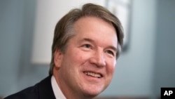 FILE - Supreme Court nominee Judge Brett Kavanaugh smiles during a meeting with Sen. Mike Lee, R-Utah, on Capitol Hill in Washington, July 18, 2018.