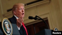 FILE - U.S. President Donald Trump answers a question at the White House in Washington, Jan. 10, 2018.