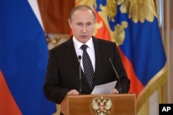 FILE - Russian President Vladimir Putin addresses members of the military at the Kremlin in Moscow, March 17, 2016.