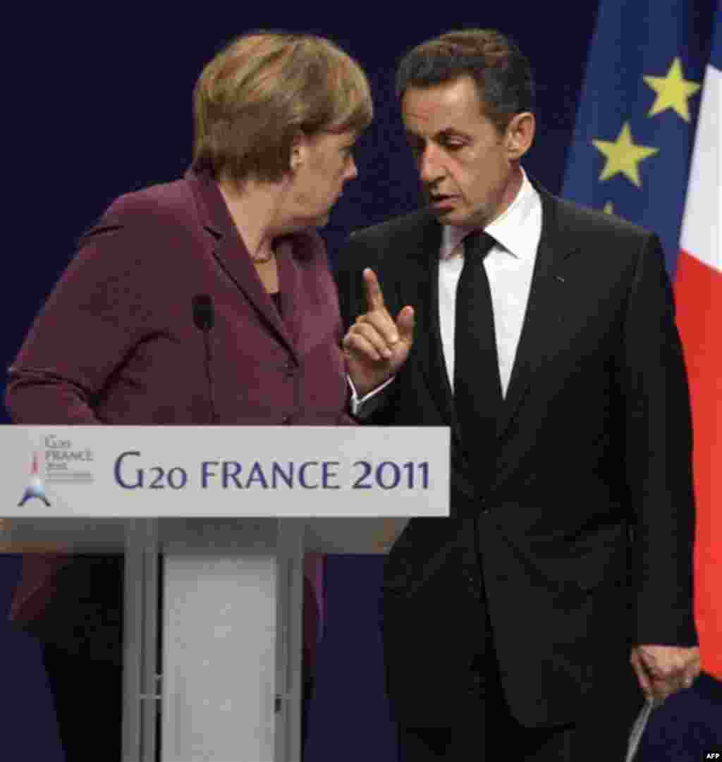 French President Nicolas Sarkozy, right, and German Chancellor Angela Merkel participate in a media conference at a G20 summit in Cannes, France on Wednesday, Nov. 2, 2011. Greek Prime Minister George Papandreou was flying to the chic French Riviera resor