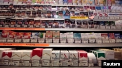 FILE - Cigarette packs are seen on shelves in a tobacco shop in Cagnes-sur-Mer, France.