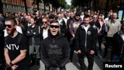 Supporters of the neo-Nazi Nordic Resistance Movement chant slogans during a demonstration at Kungsholmstorg square in Stockholm, Sweden Aug. 25, 2018. (TT News Agency/Fredrik Persson via Reuters)