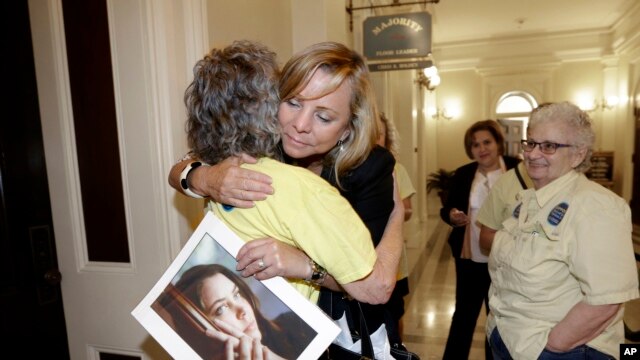 Debbie Ziegler sujeta la foto de su hija Brittany Maynard, quien tuvo que mudarse a Oregon para recibir ayuda para terminar con su vida. Brittany tenía cáncer terminal.