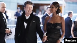 FILE - David Bowie arrives with his wife Iman to attend the CFDA fashion awards in New York, June 7, 2010.