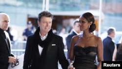 Singer David Bowie arrives with his wife Iman to attend the CFDA fashion awards in New York, June 7, 2010.