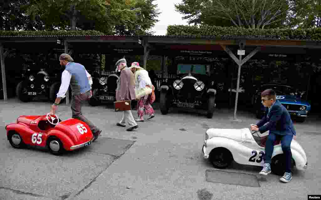 Motoring enthusiasts attend the Goodwood Revival, a three-day classic car racing festival celebrating the mid-twentieth century heyday of the sport, at Goodwood in southern Britain.