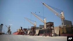 FILE - Cargo ship and oil tanker ship are idle at the port of Hodeida, Yemen, Sept. 29, 2018.