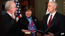 Vice President Mike Pence administers the oath of office to Health and Human Services Secretary Tom Price, accompanied by his wife Betty, Feb. 10, 2017, in the in the Eisenhower Executive Office Building on the White House complex in Washington. 
