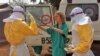 In this photo provide by MSF, healthcare workers prepare isolation and treatment areas for Ebola in Gueckedou, Guinea, Mar. 28, 2014.