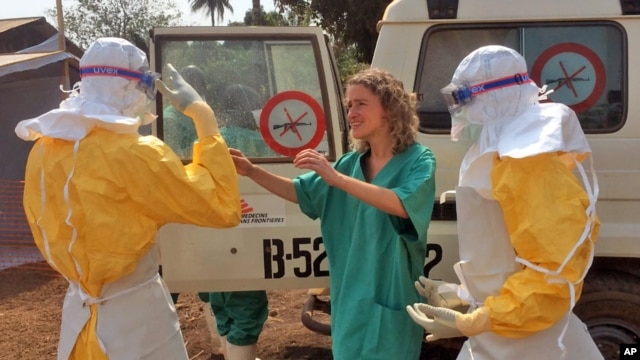 FILE - In this photo provide by MSF, healthcare workers prepare isolation and treatment areas for Ebola in Gueckedou, Guinea, Mar. 28, 2014.