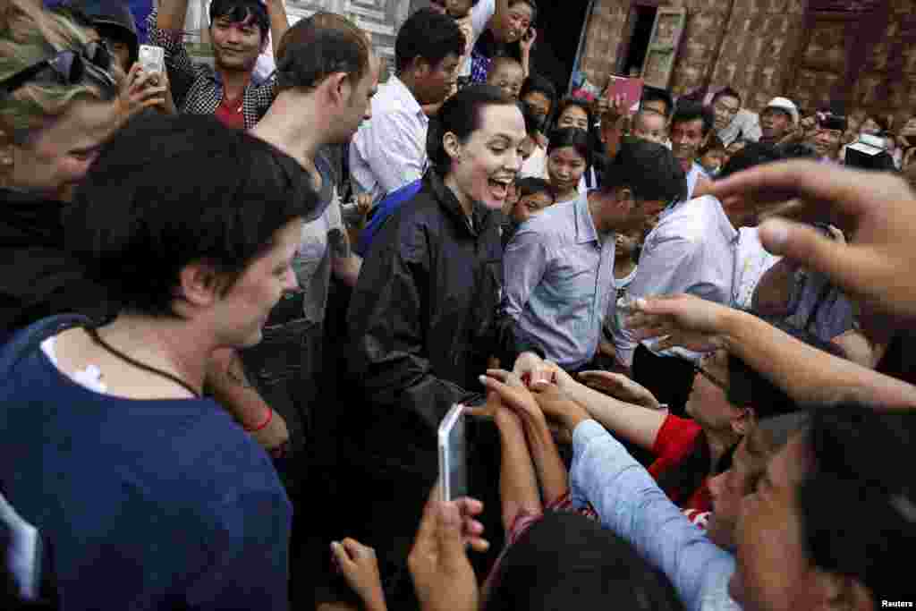 UNHCR special envoy Angelina Jolie Pitt (C) shakes hand with Kachin ethnic refugees as she visits Jam Mai Kaung IDP camp in Myitkyina capital city of Kachin state, Myanmar.