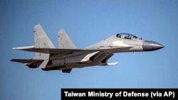 In this undated file photo released by the Taiwan Ministry of Defense, a Chinese PLA J-16 fighter jet flies in an undisclosed location. 