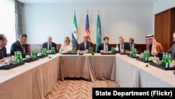 U.S. Secretary of State John Kerry sits with Saudi Arabia Foreign Minister Adel al-Jubeir (right) and Syrian Opposition Leader Dr. Riyad Nijab on Feb. 11, 2016, before a three-way meeting focused on Syria preceding the Munich Security Conference. 