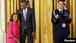 FILE - U.S. President Barack Obama presents actress and director Miriam Colon with the National Medal of Arts during a ceremony at the White House in Washington, Sept. 10, 2015.