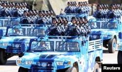 FILE - Soldiers of China's People's Liberation Army (PLA) take part in a military parade at Zhurihe military training base, in Zhurihe, Inner Mongolia Autonomous Region, China, July 30, 2017.