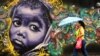 A woman passes by a graffiti in Salvador da Bahia, Brazil, June 18, 2013. 