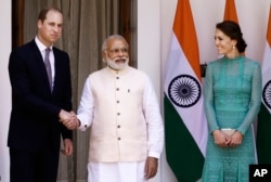 Britain's Prince William, left, and his wife Kate, the Duchess of Cambridge, right, are greeted by Indian Prime Minister Narendra Modi as they arrive for a lunch with him, in New Delhi, India, Tuesday, April 12, 2016.