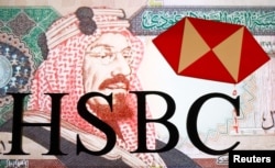 FILE - An HSBC logo is seen in front of a displayed Saudi Arabia Riyal banknote in this illustration, Aug. 8, 2017.