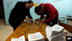 Election workers count ballots at the end of a three-day vote of the referendum on constitutional amendments at a polling station in Cairo, Egypt, April 22, 2019. 
