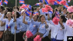Cambodian students wave their national flags during a ceremony to celebrate its Independence Day, file photo. 