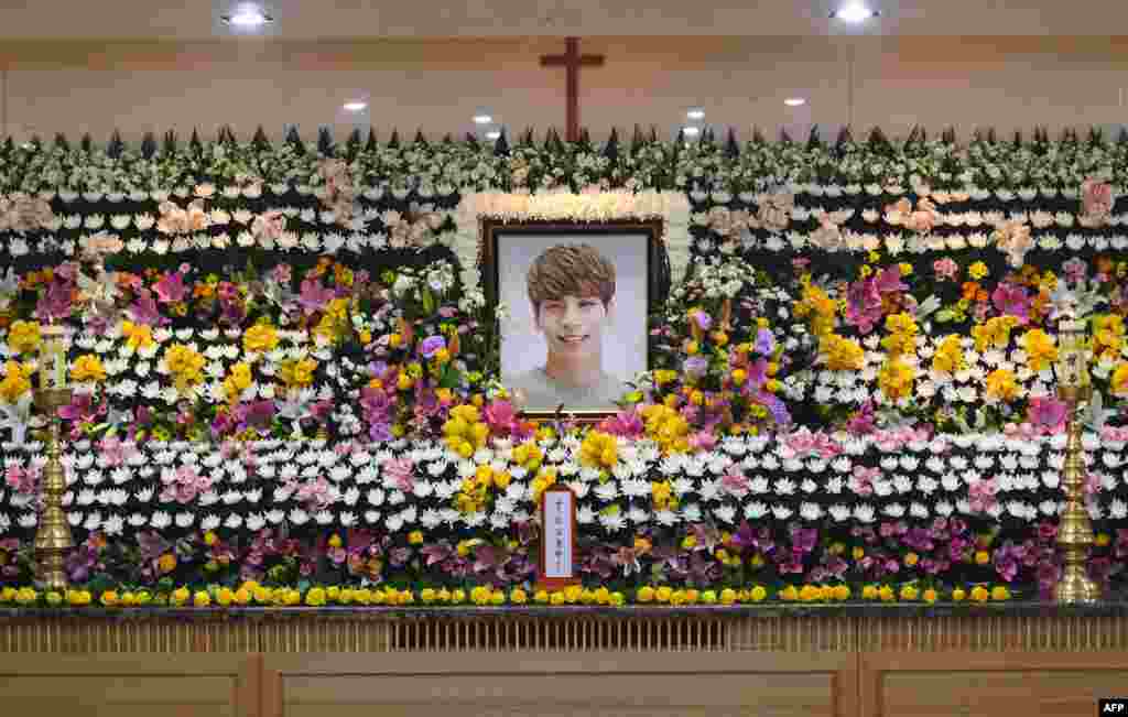 The portrait of Kim Jong-Hyun, a 27-year-old lead singer of the massively popular K-pop boyband SHINee, is seen on a mourning altar at a hospital in Seoul.