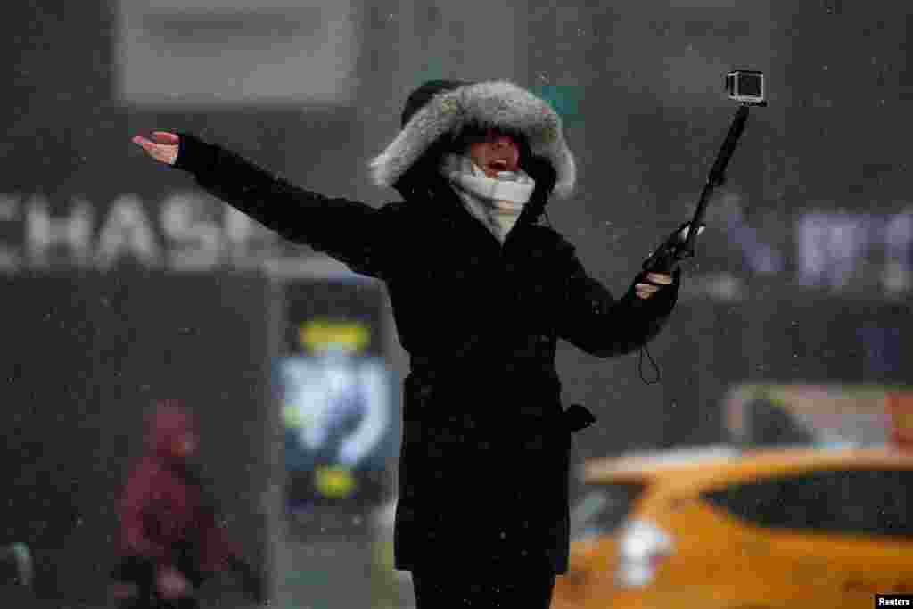 A woman takes a selfie in Times Square during a snow storm in the Manhattan borough of New York, March 14, 2017.