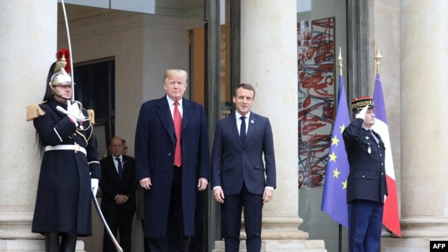 US President Donald Trump (L) is welcomed by French President Emmanuel Macron as he arrives for bilateral talks at the Elysee Palace in Paris