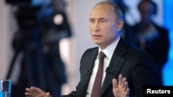 Russian President Vladimir Putin hosts a live televised call-in show, in Moscow, April 17, 2014. Putin has vowed to "kill off the blogosphere" by year's end