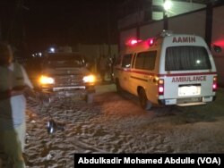 One of the Aamin ambulances waits outside Pizza House as Somali security forces end an al-Shabab siege of two Mogadishu restaurants early Thursday morning. About two dozen people were killed.