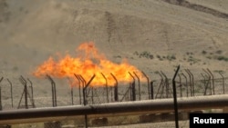 FILE - A view shows the Bai Hassan oilfield northwest of Kirkuk, July 12, 2014. A pipeline carries 150,000 barrels per day (bpd) of Kirkuk crude for export to world markets via Ceyhan, in Turkey.