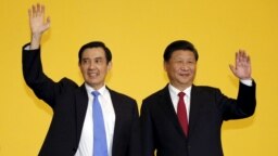 FILE - Chinese President Xi Jinping and Taiwan's then-president Ma Ying-jeou, left, wave to the media during a summit in Singapore, Nov. 7, 2015. 