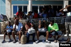 People wait at the Leonard M. Thompson International Airport during an evacuation operation after Hurricane Dorian hit the Abaco Islands in Marsh Harbour, Bahamas, September 6, 2019. REUTERS/Marco Bello