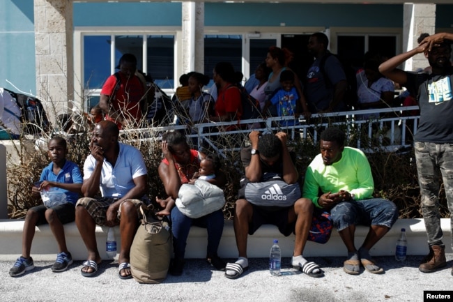 People wait at the Leonard M. Thompson International Airport during an evacuation operation after Hurricane Dorian hit the Abaco Islands in Marsh Harbour, Bahamas, September 6, 2019. REUTERS/Marco Bello
