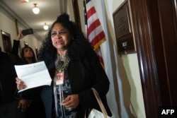 Faye Smith, a furloughed Smithsonian contract worker who has not been paid during the partial government shutdown, holds an unpaid electric bill to present to Senate Majority Leader Mitch McConnell's office on Capitol Hill in Washington, DC, Jan. 16, 2019.