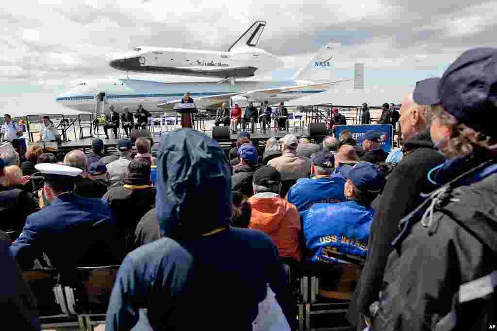 The space shuttle Enterprise, mated on the back of the NASA 747 Shuttle Carrier Aircraft, rests on the tarmac before a crowd of spectators at JFK International Airport, April 27, 2012, in New York. Enterprise is eventually going to make its new home in