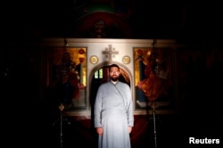 FILE - Hierodeacon Nektarije poses for a photograph at Zitomislic Serbian Orthodox monastery in Zitomislici, Bosnia and Herzegovina, July 27, 2017.