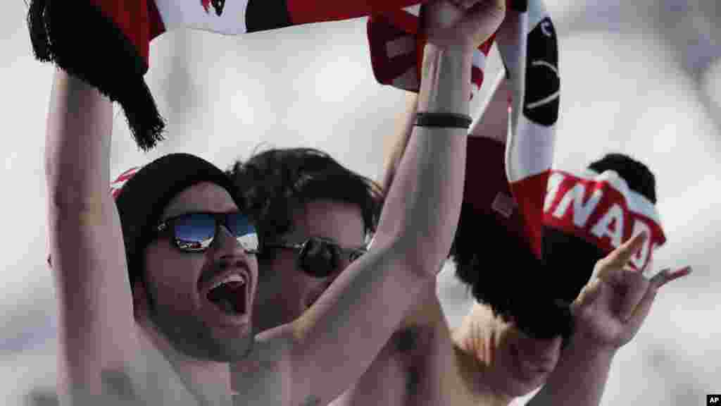 Canadian fans cheer during the men's ski slopestyle qualifying at the Rosa Khutor Extreme Park, at the 2014 Winter Olympics, Feb. 13, 2014.